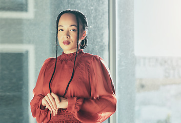 Image showing Serious, corporate and portrait of a woman at work for business, professional job or career. Office, young and an employee or worker at a company, agency or workplace by a window and working