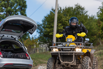 Image showing Adventurous driving of ATV motorbikes. A man drives a quad bike on dangerous roads