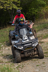 Image showing Adventurous driving of ATV motorbikes. A man drives a quad bike on dangerous roads