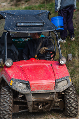 Image showing Adventurous driving of ATV motorbikes. A man drives a quad bike on dangerous roads