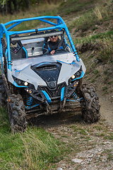 Image showing Adventurous driving of ATV motorbikes. A man drives a quad bike on dangerous roads