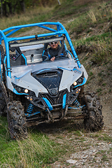 Image showing Adventurous driving of ATV motorbikes. A man drives a quad bike on dangerous roads