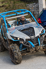 Image showing Adventurous driving of ATV motorbikes. A man drives a quad bike on dangerous roads