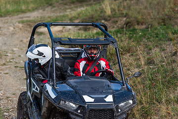 Image showing A man driving a quad ATV motorcycle through beautiful meadow landscapes