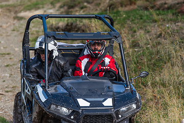 Image showing A man driving a quad ATV motorcycle through beautiful meadow landscapes