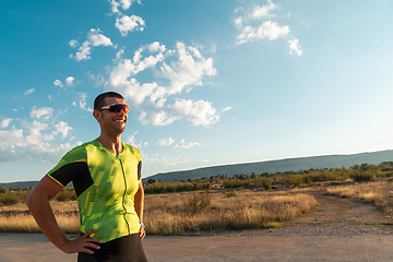 Image showing A triathlete resting after a hard morning's run. Training preparation for the upcoming marathon