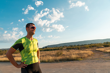 Image showing A triathlete resting after a hard morning's run. Training preparation for the upcoming marathon