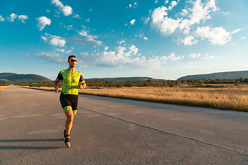 Image showing Triathlete in professional gear running early in the morning, preparing for a marathon, dedication to sport and readiness to take on the challenges of a marathon.