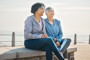 Image showing Senior women, sitting and beach with friends, training and laugh in summer outdoor. Exercise, break and mature female in the morning with funny joke and workout for wellness and health by sea