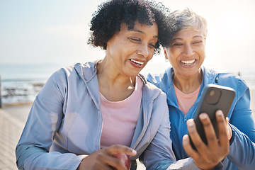 Image showing Senior women, phone and social media in nature for a chat, notification or a funny meme. Happy, reading online and elderly friends by the sea with a mobile app for communication or internet memory