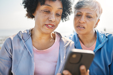 Image showing Phone, confused and senior friends on the beach together, browsing social media or reading a text message. Communication, summer and elderly women on the coast with a mobile to search for information