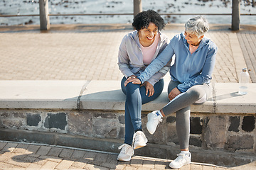 Image showing Senior women, bench sitting and beach with friends, training and laugh in summer outdoor. Exercise, break and mature female in the morning with funny joke and workout for wellness and health by sea