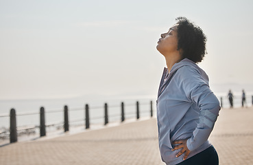 Image showing Beach, tired and woman with fitness, sports and health with wellness, workout goals and running. Outdoor, female person or athlete breathing, exercise and mockup space with fatigue, ocean and profile