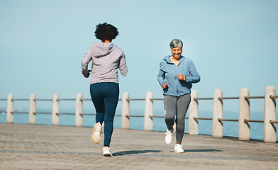 Image showing Running, fitness and senior friends by sea with mature women and smile from marathon. Exercise, workout and training on beach promenade path for health and wellness in the morning with happy people