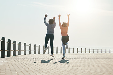 Image showing Fitness, jump and freedom with friends at beach for celebration, motivation and training. Cardio, workout and health with mature women in nature for running, energy and exercise goals together