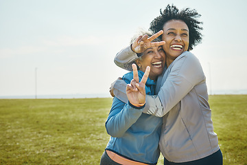 Image showing Senior, women hug and fitness, peace hand sign and portrait with friends, energy and playful outdoor. Happy female people, friendship and cool with sportswear in park, exercise and fun together