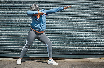 Image showing Woman, fitness and dab dance outdoor at training, exercise or workout achievement with celebration. Mature runner lady, comic dancing and winner in city with mindset, freedom or commitment to health