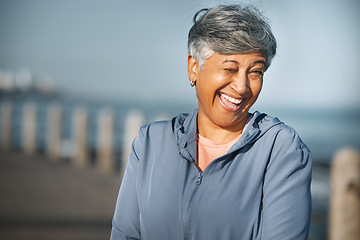 Image showing Senior, fitness and woman portrait with wink at beach happy with walking, running or morning cardio in nature. Smile, face and cheerful elderly female at the sea for workout, exercise or sports walk