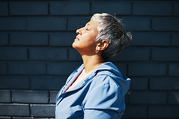 Image showing Senior woman, fitness and thinking with sunshine, vitamin d and relax outdoor at training, exercise or workout. Mature runner lady, sunbathing and city with mindset, peace and commitment to health