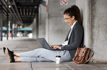 Image showing Laptop, typing and woman on a coffee break in the city or employee relax on social media, internet or online connection. Remote, virtual work and digital nomad or person sitting on computer on street