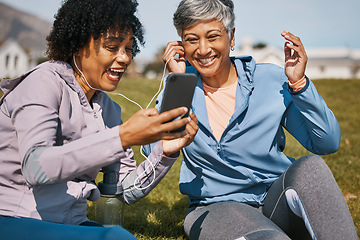 Image showing Senior woman, daughter and outdoor phone call or listening to news, announcement or social media, blog or podcast about workout. Elderly mother, girl and share earphones together on screen