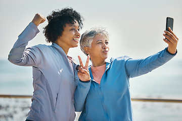 Image showing Selfie, mature women and fitness with peace sign and photo for social media by the sea. Photograph, female friends and motivation for running, workout and wellness together with profile picture