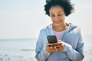 Image showing Fitness, beach and senior woman with smartphone, typing and social media with connection, network and smile. Happy person, pensioner and old lady with a cellphone, happiness and contact with message