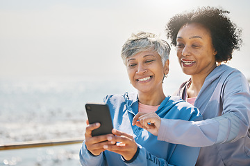 Image showing Senior woman, daughter and reading phone at the beach or social media, blog or post about workout or walk on promenade. Elderly mother, girl and profile picture with water or together on screen