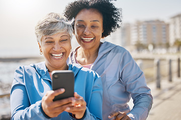 Image showing Senior woman, daughter and outdoor with phone or reading social media, blog or post about workout or walk in the park. Elderly mother, girl and profile picture on the beach or together on screen