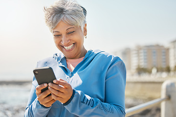 Image showing Fitness, beach and senior woman with cellphone, happiness and social media with network, email and smile. Happy person, pensioner and elderly lady with a smartphone, seaside and contact with message