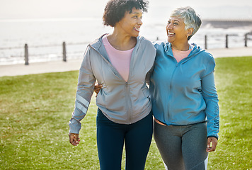 Image showing Hug, fitness and senior friends in nature for morning walking, quality time and retirement in park. Smile, talking and elderly women with care, love and together on field by promenade for laughing