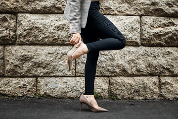 Image showing Outdoor, heels fix and business woman on road with shoes and job fashion on work commute. City travel, female professional and walking on a urban pavement, street and sidewalk with legs and hands