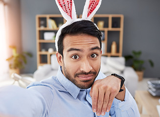Image showing Bunny ears, holiday and selfie with a man and remote work on easter with creative job. Celebration, happy and male professional from Spain feeling silly and goofy with comedy rabbit hat in a home