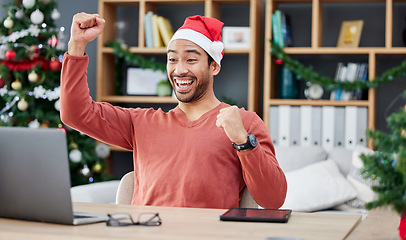 Image showing Laptop, christmas and remote work with a winner man in his home office for the celebration of an achievement. Computer, success and motivation with a happy entrepreneur cheering a sale, bonus or deal