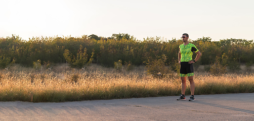 Image showing A triathlete resting after a hard morning's run. Training preparation for the upcoming marathon