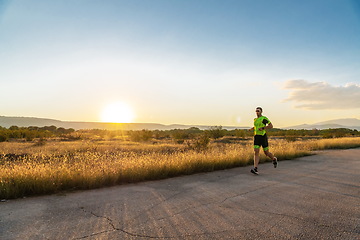 Image showing Triathlete in professional gear running early in the morning, preparing for a marathon, dedication to sport and readiness to take on the challenges of a marathon.