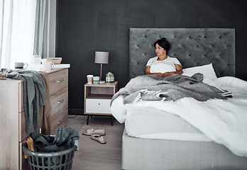 Image showing Depression, mental health and a senior woman in bed feeling sad or down in her messy home alone. Insomnia, retirement and an elderly female person in her bedroom feeling lonely with bipolar disorder