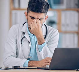 Image showing Man, doctor and headache with laptop in stress, mistake or debt from burnout or deadline at hospital. Frustrated male person or medical employee in anxiety, depression or mental health at the clinic