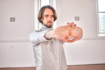 Image showing Exercise, fencing and man stretching, fitness and training with wellness, athlete and workout for competition. Health, sword fighting and male person warm up arms for challenge, match and sports