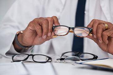 Image showing Hands, man and optician with choice of glasses for vision, eyesight and prescription eye care. Closeup of doctor, optometrist and decision for frame, lens and eyewear of optical healthcare assessment