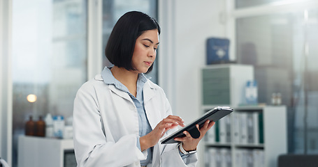 Image showing Tablet, typing and woman or doctor, hospital or clinic office for healthcare software, telehealth or research. Search, online charts or report of medical professional or asian person on digital tech