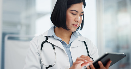 Image showing Woman, doctor and tablet for healthcare search, typing and clinic or hospital software, telehealth or research. Office, online charts or report of medical professional or asian person on digital tech