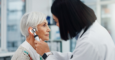 Image showing Senior woman, doctor and otoscope for ear, hearing test and exam, audio check or consultation for healthcare. Ent, otolaryngology and medical professional with elderly person for wellness in hospital