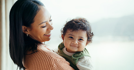 Image showing Mother, newborn and smile by window, home and happy together with care, love and bonding in childhood. Mom, infant baby and excited with connection, development and hug at family house in Canada