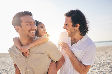 Image showing Happy, piggyback and lgbt family at the beach for love, care and a vacation in summer. Smile, nature and gay parents laughing with a child at the sea during a holiday for bonding, comedy or travel