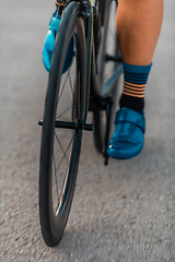 Image showing Close up of the pedals of a bicycle being ridden by a professional triathlete preparing for training