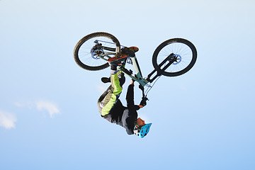 Image showing Bike, man and upside down in sky for action, bicycle stunt and challenge on mockup space. Biker, sports athlete and courage for air jump, energy and freedom of risk in cycling contest, race and show