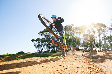 Image showing Bicycle, wheelie and man with ramp, outdoor and speed for sport, race or adventure in summer, fitness or nature. Extreme cycling, person and jump for trail, exercise or challenge for workout in dirt