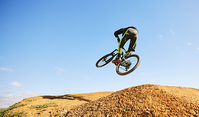 Image showing Bicycle, man and jump in air, dirt and outdoor for sports, race or adventure in summer, woods or nature. Extreme cycling, person and freedom for trail, mockup space or challenge for fitness in forest