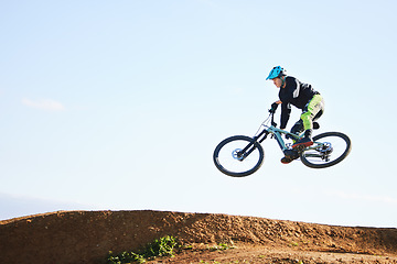 Image showing Cycling, sports and man jump with bicycle for adrenaline on adventure, freedom and in air for speed. Mountain bike, tricks and cyclist for training, exercise and fitness on dirt road, trail and track